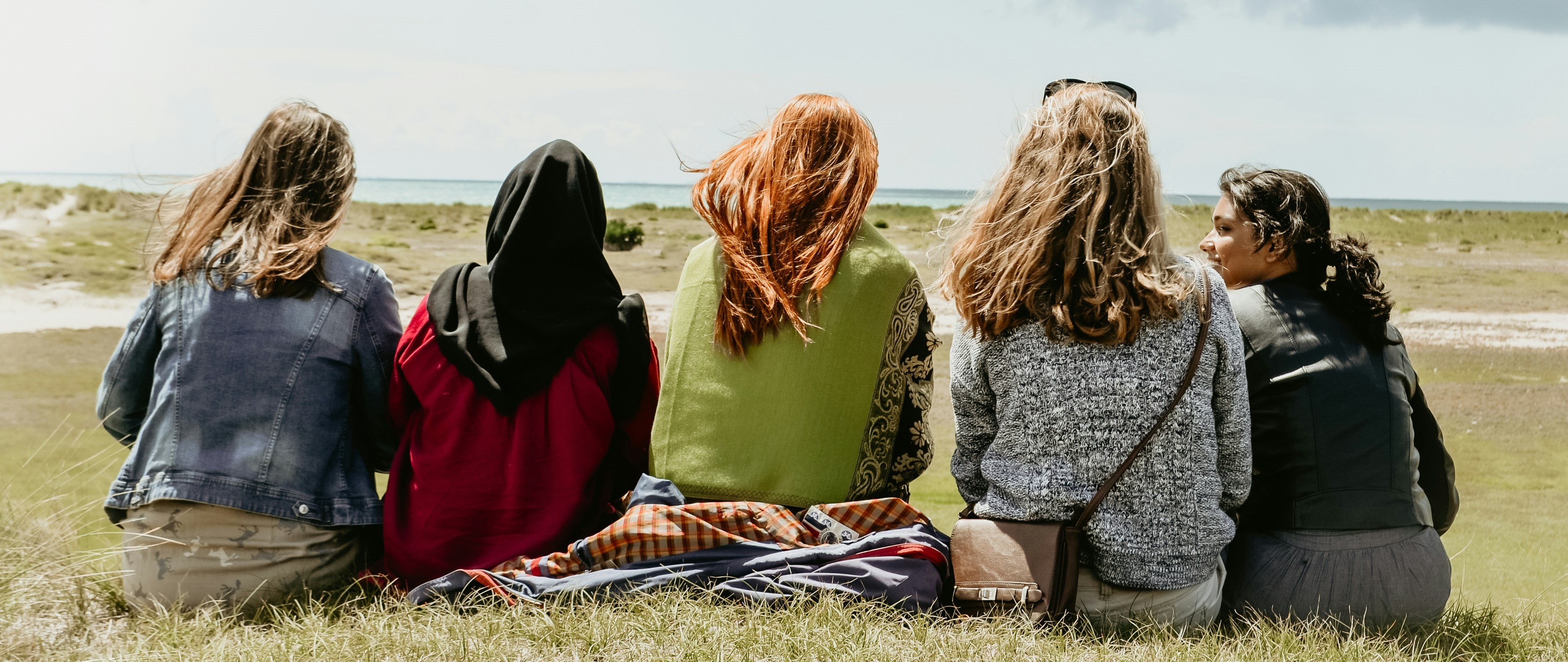 women sitting in a field